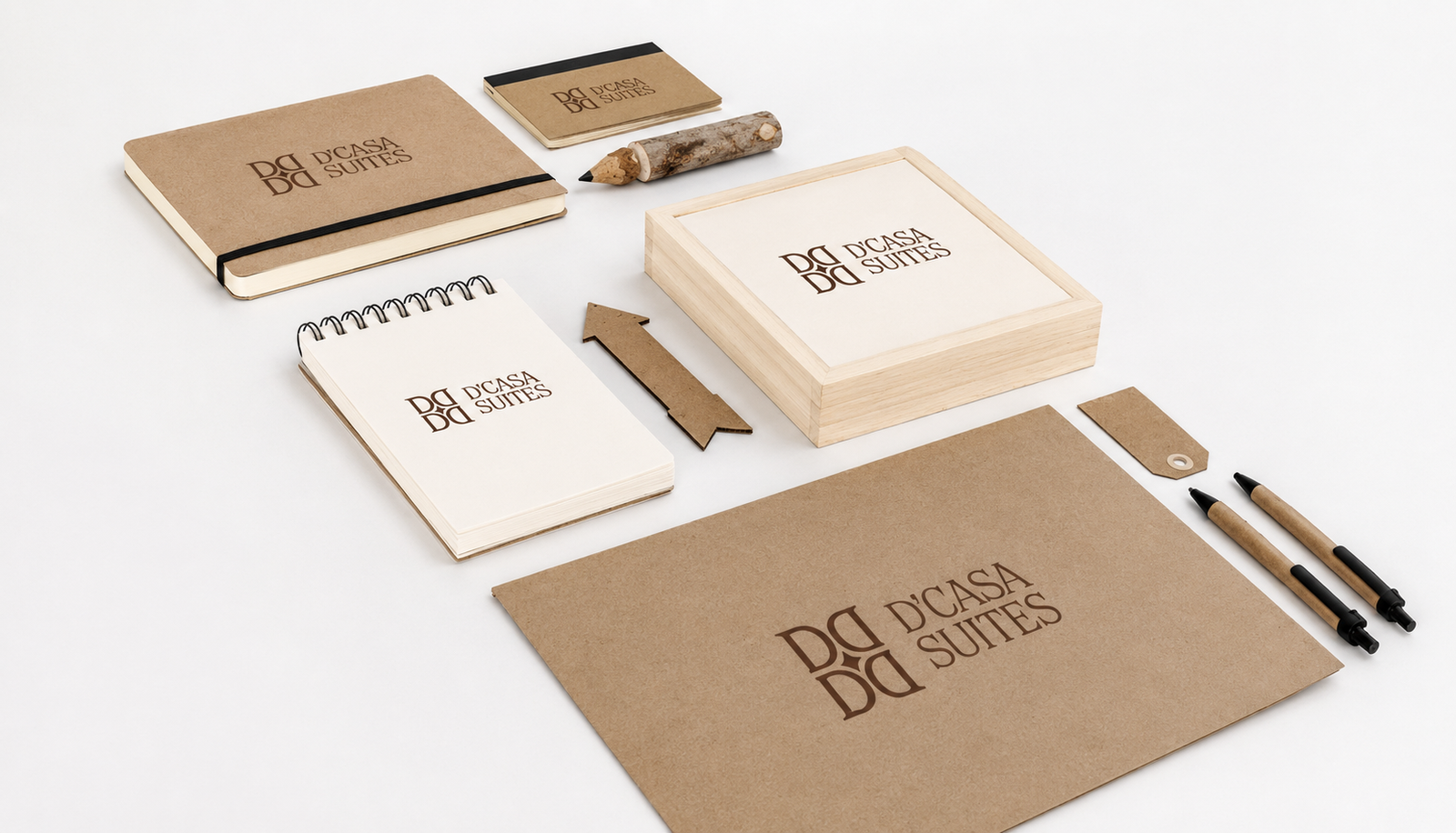 D'CASA Suites stationery — notebooks, envelope, pens, and wooden box