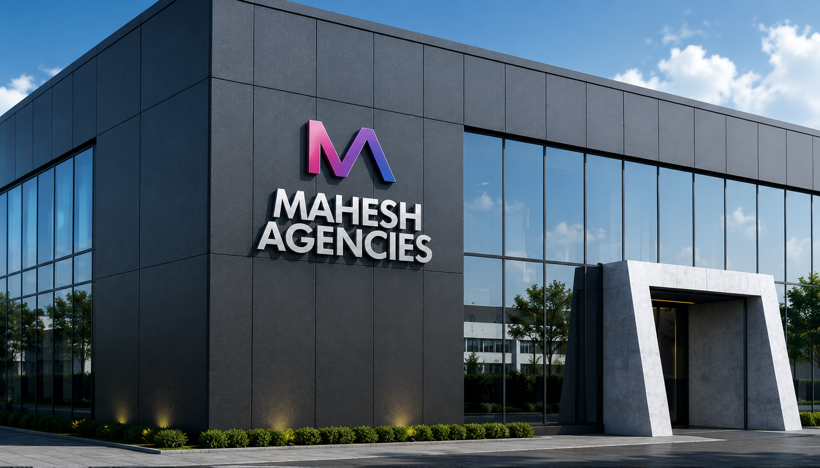Mahesh Agencies logo mounted on a modern office building facade